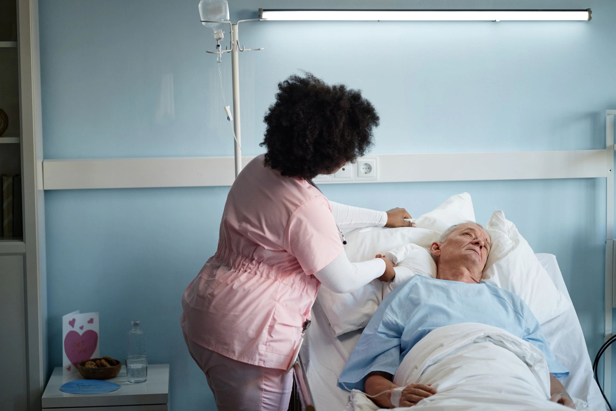 Care worker supporting an elderly resident